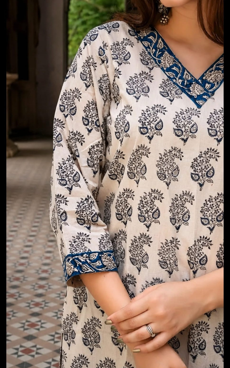 cotton short kurti in V-neck, calf length, sleeve length is three quater